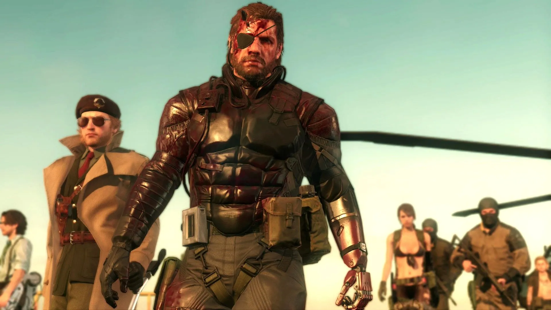 Các nhân vật Huey Emmerich, Kazuhira Miller, Venom Snake và Quiet cùng binh lính khác nhìn vào màn hình trong Metal Gear Solid V: The Phantom Pain.