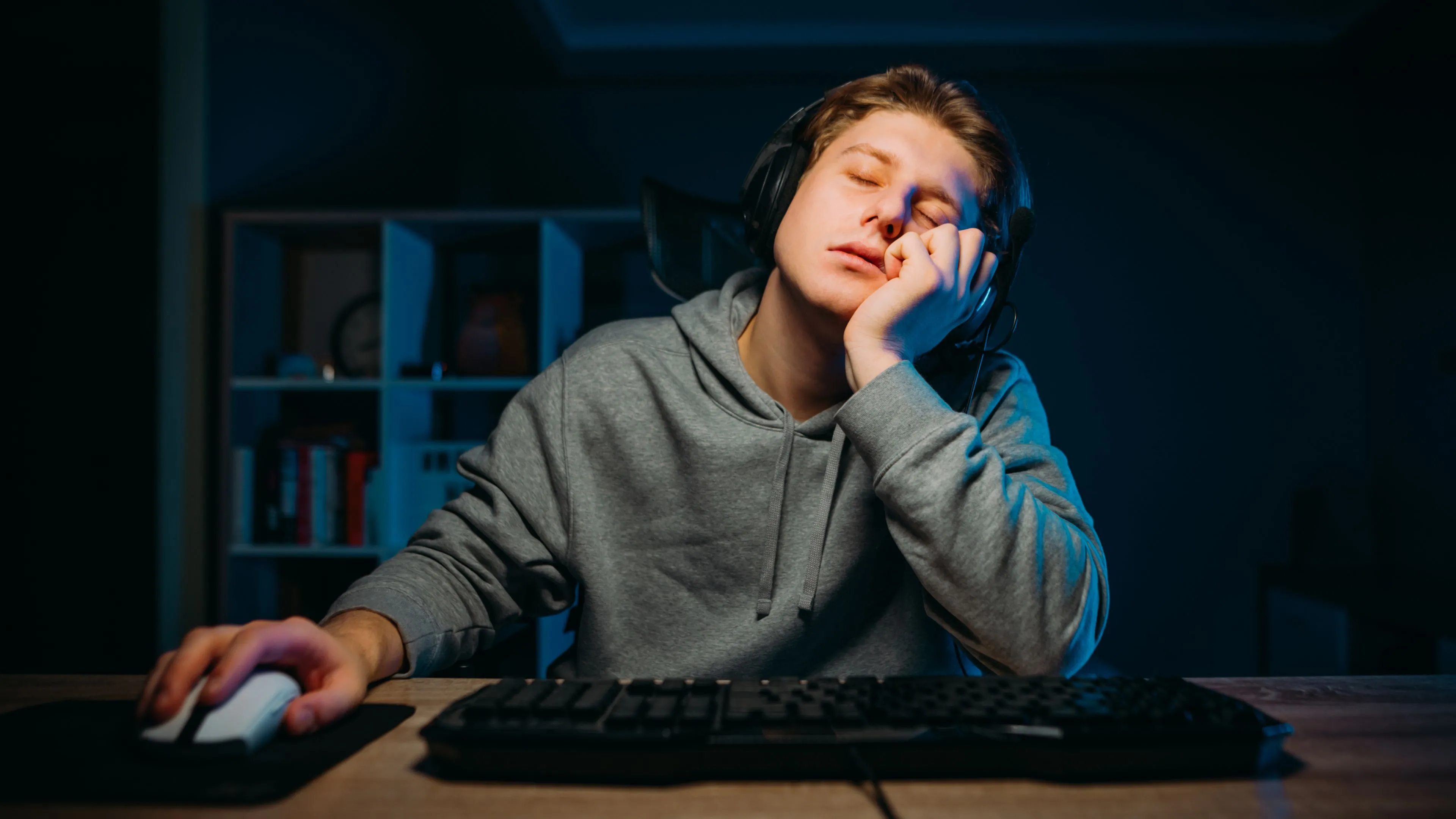 Một game thủ buồn ngủ ngồi gục tại bàn làm việc, ước có thể &quot;ngủ ngay lập tức&quot; như máy tính.